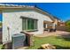 Inviting backyard with a cozy patio, partial synthetic grass, and cornhole game at 3129 E Franklin Ave, Gilbert, AZ 85295