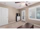 Bright bedroom with shuttered window, television, and a door to a private outdoor space at 3129 E Franklin Ave, Gilbert, AZ 85295