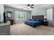 Bright primary bedroom with ample natural light and a ceiling fan at 3129 E Franklin Ave, Gilbert, AZ 85295