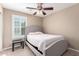 Bedroom featuring a ceiling fan, carpet and a large window with shutters at 3129 E Franklin Ave, Gilbert, AZ 85295