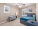 Bedroom with ceiling fan, shutters, and carpet floors at 3129 E Franklin Ave, Gilbert, AZ 85295