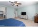 Well-lit bedroom with a ceiling fan and a TV at 3129 E Franklin Ave, Gilbert, AZ 85295