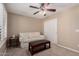 Cozy bedroom featuring neutral tones, a comfortable couch, and a ceiling fan for added comfort at 3129 E Franklin Ave, Gilbert, AZ 85295