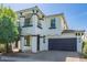 Two story home with a well manicured lawn and beautiful desert landscaping in front at 3129 E Franklin Ave, Gilbert, AZ 85295