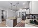 Well-equipped kitchen with granite counters, stainless steel appliances, and a center island at 3129 E Franklin Ave, Gilbert, AZ 85295