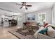 Open-concept living room with an adjacent kitchen and dining area at 3129 E Franklin Ave, Gilbert, AZ 85295