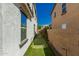 Narrow side yard featuring synthetic grass and privacy walls, ideal for low-maintenance landscaping at 3129 E Franklin Ave, Gilbert, AZ 85295