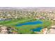 Breathtaking aerial view of golf course community featuring lush fairways, sparkling ponds, and scenic Arizona landscape at 3564 N Tuscany --, Mesa, AZ 85207