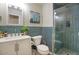 Stylish bathroom featuring modern vanity, vibrant teal tile accent, and glass-enclosed shower at 3564 N Tuscany --, Mesa, AZ 85207