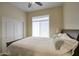 Cozy bedroom with a ceiling fan, a large window providing plenty of natural light, and a double closet at 3564 N Tuscany --, Mesa, AZ 85207