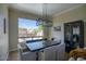 Elegant dining room featuring a modern light fixture, wooden table with bench and view to the pool at 3564 N Tuscany --, Mesa, AZ 85207