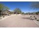 Rolling Hills gated entrance with desert landscaping, brick walls, and manicured shrubbery at 3564 N Tuscany --, Mesa, AZ 85207