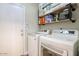 Well-organized laundry room with a washer, dryer, and ample shelving for storage at 3564 N Tuscany --, Mesa, AZ 85207