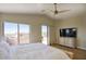 Bright primary bedroom with ceiling fan, large windows, and access to a private balcony at 3564 N Tuscany --, Mesa, AZ 85207