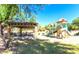 Community playground and picnic area with covered tables, a slide, and swings, offers fun for all at 3564 N Tuscany --, Mesa, AZ 85207