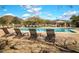 Community pool featuring plenty of lounge chairs, a covered gazebo, and views of the surrounding mountains at 3564 N Tuscany --, Mesa, AZ 85207