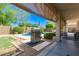 Outdoor grill area on the covered patio overlooking the sparkling pool and lush backyard at 3871 S Marion Way, Chandler, AZ 85286
