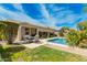 Backyard with covered patio, lush landscaping, and a sparkling pool for relaxing at 3871 S Marion Way, Chandler, AZ 85286