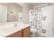 Bright bathroom featuring a single sink vanity and shower with a floral curtain at 3871 S Marion Way, Chandler, AZ 85286