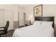 Well-lit bedroom with a closet, desk and simple decor at 3871 S Marion Way, Chandler, AZ 85286