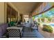 Relaxing covered patio features comfortable seating and overlooks the pool and yard at 3871 S Marion Way, Chandler, AZ 85286