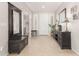 Spacious entryway boasting neutral colored tile and large dark wood furnishings at 3871 S Marion Way, Chandler, AZ 85286