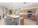 Modern kitchen featuring stainless steel appliances and a breakfast bar with seating at 3871 S Marion Way, Chandler, AZ 85286