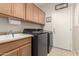A tidy laundry room features a washer, dryer, sink, and ample cabinet storage at 3871 S Marion Way, Chandler, AZ 85286