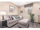 Cozy living room featuring a plush sofa and ample natural light at 3871 S Marion Way, Chandler, AZ 85286