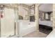 Well-lit main bathroom featuring a bathtub and a separate shower enclosure at 3871 S Marion Way, Chandler, AZ 85286