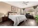 Spacious main bedroom with a ceiling fan and a dedicated office space at 3871 S Marion Way, Chandler, AZ 85286