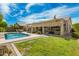 Beautiful backyard featuring a large pool, covered patio, and manicured lawn at 3871 S Marion Way, Chandler, AZ 85286
