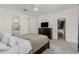 A spacious bedroom with ensuite bathroom, walk-in closet, and TV on dresser at 399 N 157Th Ln, Goodyear, AZ 85338