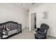 Bedroom featuring a crib, rocking chair, and ample space for a growing Gathering at 399 N 157Th Ln, Goodyear, AZ 85338