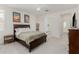 A serene main bedroom featuring neutral colors, ceiling fan, and ensuite bathroom at 399 N 157Th Ln, Goodyear, AZ 85338