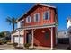 Charming two-story home features a red exterior with blue shutters and a well-manicured front yard at 399 N 157Th Ln, Goodyear, AZ 85338