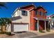 Charming two-story home features a red exterior with blue shutters and a well-manicured front yard at 399 N 157Th Ln, Goodyear, AZ 85338