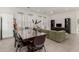 An inviting living room featuring a dining area, green sofa and media center at 399 N 157Th Ln, Goodyear, AZ 85338