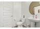 A clean and crisp powder room with modern fixtures and a pedestal sink at 399 N 157Th Ln, Goodyear, AZ 85338