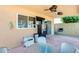 Back patio area with custom landscaping, outdoor kitchen, and a ceiling fan at 4050 W Camino Del Rio --, Glendale, AZ 85310