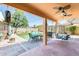 Covered patio with lush landscaping and a built-in outdoor kitchen area at 4050 W Camino Del Rio --, Glendale, AZ 85310