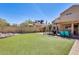 This backyard boasts artificial turf, a secure dog run, and an inviting outdoor dining area at 4050 W Camino Del Rio --, Glendale, AZ 85310
