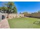 Spacious backyard featuring lush artificial turf, enhancing the landscape's appeal with low maintenance requirements at 4050 W Camino Del Rio --, Glendale, AZ 85310