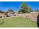 Well-maintained backyard showcasing artificial turf, a storage shed, and decorative garden elements at 4050 W Camino Del Rio --, Glendale, AZ 85310