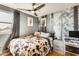 Cozy bedroom featuring a ceiling fan, hardwood floors and stylish wall art at 4050 W Camino Del Rio --, Glendale, AZ 85310
