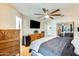 This bedroom has hardwood floors, ceiling fan, TV, and access to a closet at 4050 W Camino Del Rio --, Glendale, AZ 85310