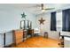 Bedroom with hardwood floors, ceiling fan, vanity, and ample lighting at 4050 W Camino Del Rio --, Glendale, AZ 85310