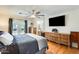 This bedroom has hardwood floors, ceiling fan, TV, and French doors to the outside at 4050 W Camino Del Rio --, Glendale, AZ 85310