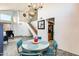 Stylish dining area with a retro table set, and an open view of the staircase and kitchen, creating a welcoming space at 4050 W Camino Del Rio --, Glendale, AZ 85310