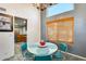 Bright dining area featuring a retro table set, chandelier, and a large window, creating a cozy and inviting space at 4050 W Camino Del Rio --, Glendale, AZ 85310